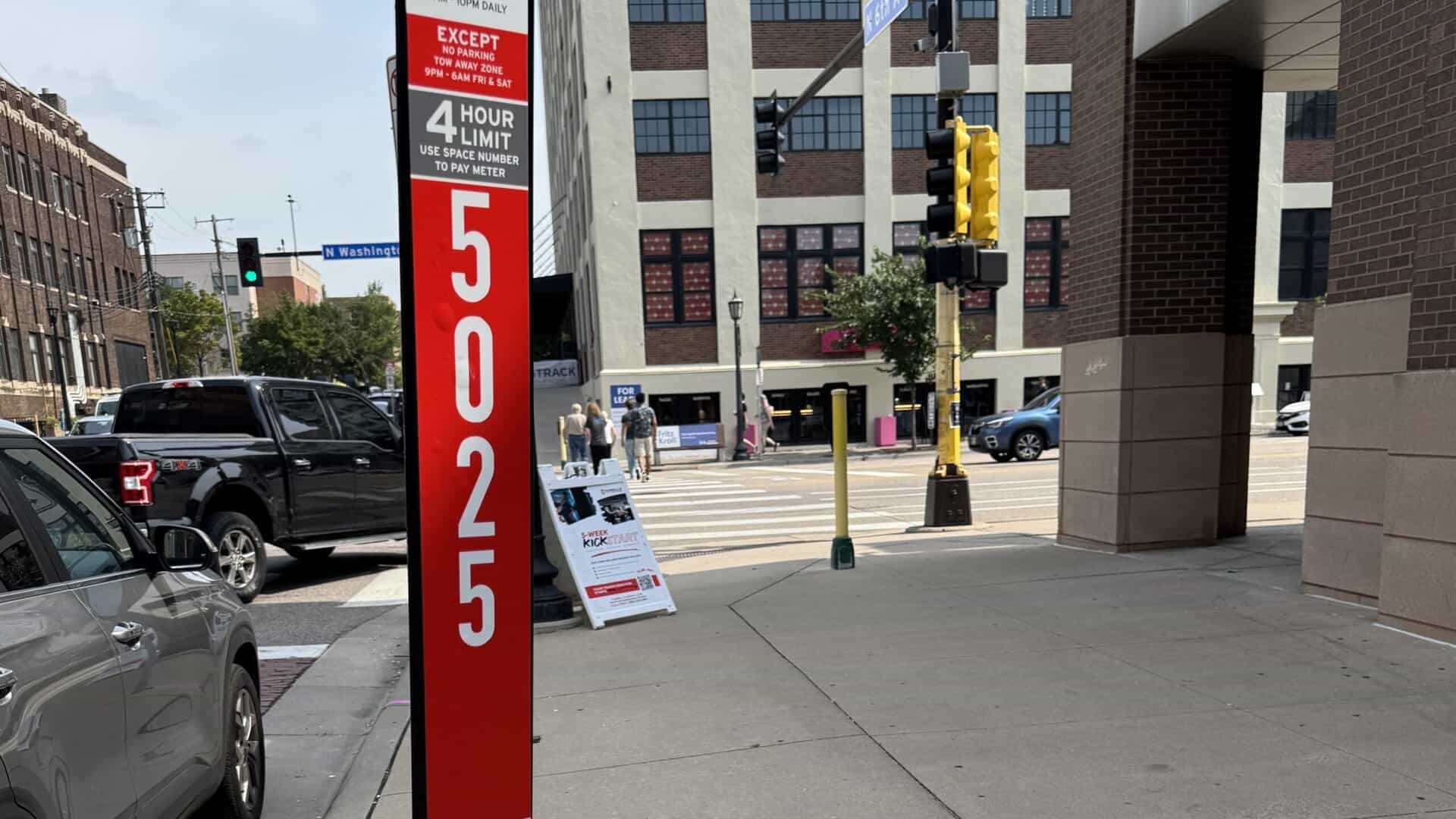 photo of a parking meter with red signage 